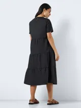Vestido midi negro de corte suelto con mangas cortas y cuello redondo.