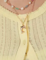 Set de dos collares cortos, uno de perlas sintéticas y otro de metal dorado con dije de delfín.