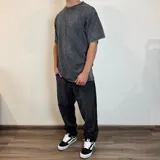 Remera gris con efecto lavado y estampado de una fotografía de la playa en la espalda. Corte oversize.