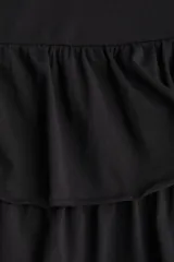 Minifalda negra de punto suave de algodón, con cintura de doble capa, corte holgado, costura fruncida sobre la cadera y fruncido escalonado con bordes enrollados.