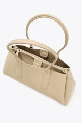 Bolso tipo city color beige, con doble asa corta y compartimento interno con cierre.