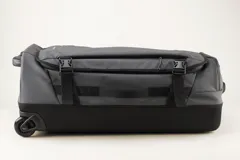 Valija gris con ruedas, manija extensible y correas de ajuste externas.