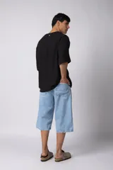 Remera negra de tejido tipo lino, corte holgado y cuello redondo. Sin estampas ni bordados.