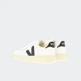 Championes Veja V-10 de cuero blanco con logo lateral en forma de V color negro y detalles en el talón color negro.