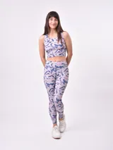 Top deportivo corto estampado con flores abstractas en tonos azul, lila y rosa. Diseño de espalda deportiva.
