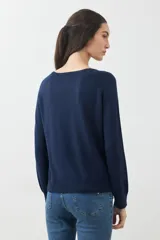 Sweater básico de tejido de punto color beige, de corte recto y mangas largas.