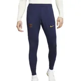Pantalón de fútbol Nike del Paris Saint-Germain, modelo Strike. Diseño azul marino con detalles en dorado y patrón geométrico en la parte inferior de las piernas.