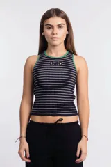 Musculosa corta a rayas horizontales negras y blancas, con cuello y sisas ribeteadas en verde. Presenta un logo ovalado en el pecho.