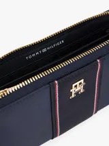 Billetera grande con cremallera Tommy Hilfiger, color azul marino, con insignia dorada con el monograma TH en la parte delantera y detalle de tejido trenzado.