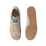 Zapatilla deportiva Adidas modelo SL 72 RS, color beige con tres franjas laterales blancas. Presenta detalles en gamuza y nylon, forro interior blanco y etiqueta en la lengüeta con detalles azules. La suela es de goma con patrón dentado.