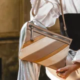 Bolso de mano color borgoña con paneles diagonales en color crema.
