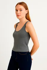 Musculosa gris de poliéster, sin mangas, corte holgado y cuello redondo.