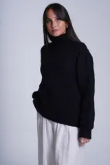 Sweater rojo de punto trenzado con cuello alto.