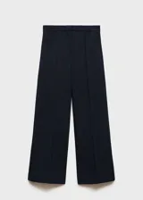 Pantalón wideleg color azul marino, de tiro medio y diseño palazzo. Presenta bolsillos laterales y traseros de ribete, cierre oculto con botón, gancho y cremallera. Diseño crop.