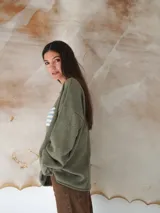 Sweater beige de hilo de algodón con cuello redondo y manga larga. Estampado con la bandera de Uruguay en el frente.