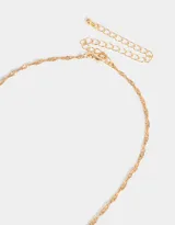 Cadena corta dorada con dije de la letra A cubierto de strass.