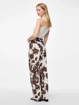 Pantalón de jean ancho con estampado de cebra en tonos marrones y blancos.