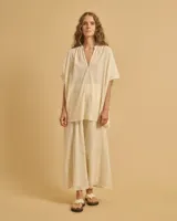 Túnica color crema con mangas anchas, cuerpo acampanado y escote en V.