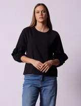 Blusa de gasa color crema con estampado de flores amarillas, de manga 3/4 con volados.