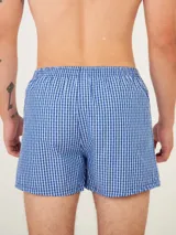 Bóxer de algodón blanco con estampado de flores pequeñas color celeste, con cintura elástica y logo de la marca en el centro.