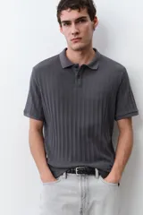 Remera polo gris de punto texturizado de peso medio, corte slim fit, manga corta, cuello clásico, tapeta de botones y bajo recto.
