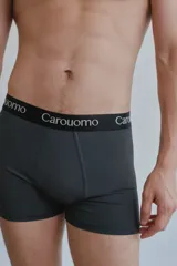 Boxer gris oscuro de microfibra lisa con elástico negro personalizado con el logo de la marca en blanco.