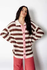 Camisa de algodón a rayas horizontales color chocolate y crudo, con cuello camisero, cierre frontal con botones y mangas largas. Corte holgado y estilo vintage.