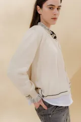 Saco tejido color negro con detalle en escote y puños a dos tonos, corte acampanado y detalle en la espalda con cambio de punto y color.