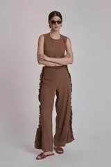 Pantalón marrón de corte recto con volados en los laterales.