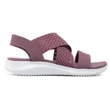 Sandalia tipo pala de color lila con parte superior de tejido elástico suave y tiras cruzadas, ofreciendo confort y estilo casual.