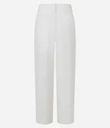 Pantalón baggy de tiro medio color blanco, confeccionado en sarga de algodón. Cuenta con trabillas en la cintura, cuatro bolsillos, cierre con cremallera, lateral desplazado y costuras contrastantes.