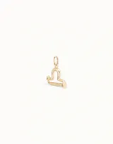 Dije plateado con forma del signo zodiacal Libra.