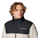 Campera puffer Columbia Powder Lite II, color beige con canesú negro, cierre frontal completo, bolsillos laterales con cierre y logo de la marca bordado en el pecho.