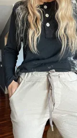 Pantalón de vestir color beige, de corte recto, con bolsillos laterales y traseros. Se ajusta a la cintura con cordón.