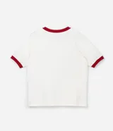 Remera blanca de algodón y elastano con cuello y mangas cortas con borde rojo. Estampa frontal del personaje Stitch de Disney.