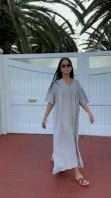 Vestido largo rojo de lino, con escote en V y corte en forma de U debajo del busto. De corte amplio y mangas cortas.