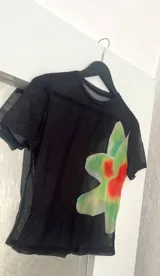 Top negro de microtul con estampado de flores rojas y verdes.