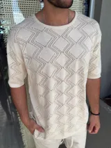 Buzo color beige de tejido calado con diseño de rombos, cuello redondo y mangas cortas.