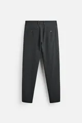 Pantalón slim fit negro confeccionado en tejido con elasticidad en ambas direcciones. Cuenta con bolsillos frontales y traseros de vivo con botón. Cierre frontal con cremallera y botón.