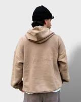 Hoodie color beige de felpa con frisa gruesa, corte boxy y estampado en la espalda con la frase "to be continued".