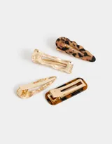 Set de cuatro hebillas para el pelo en acrílico con diferentes formas y estampados carey y dorado.