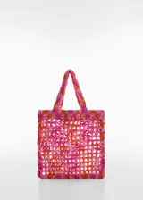 Bolso tipo tote tejido a crochet en tonos rosa y naranja.