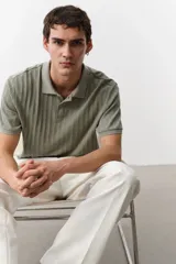 Remera polo verde salvia de punto texturizado, corte slim fit, manga corta, cuello clásico y tapeta con dos botones.