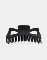 Broche negro grande para el pelo, con forma de mandíbula y dientes para sujetar el cabello.