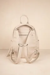 Mochila negra de cuero sintético con diseño minimalista, formato compacto y estructura blanda. Incluye bolsillo delantero con broche y cierre metálico superior con tiradores largos.