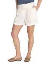 Short de tiro alto color crudo, confeccionado en lino orgánico, con cierre cruzado, hebillas en los costados, bolsillos y pinzas.