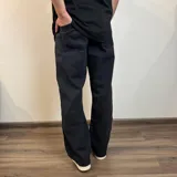 Pantalón de jean gris oscuro con efecto lavado, corte holgado y tiro medio.
