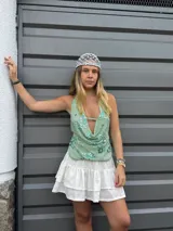 Top verde agua con escote drapeado, espalda descubierta y bordado de flores azules y lentejuelas.