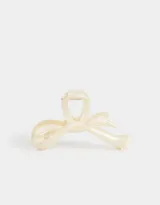 Broche para el pelo color crema con forma de moño.