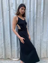 Vestido largo negro de tejido de punto con detalle de lentejuelas en la cintura y espalda descubierta con tirantes finos.